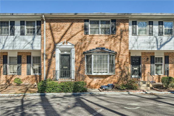 Front view of a townhouse with brick facade and white trim.