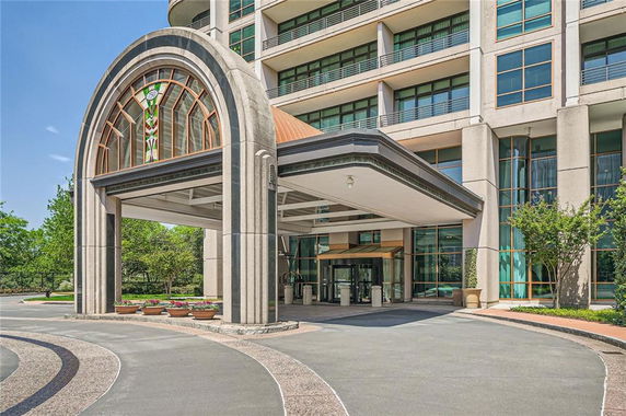 Front view of a multi-story building with a decorative entrance canopy.
