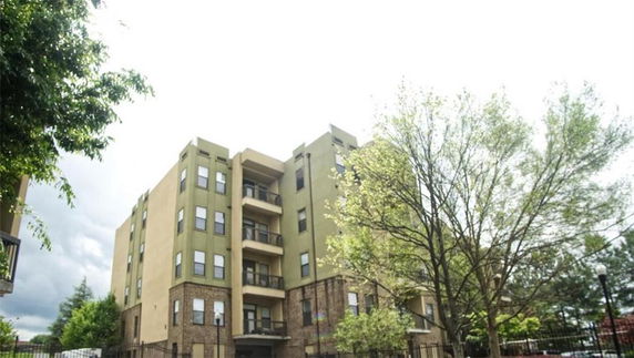 Front view of a multi-story apartment building with balconies