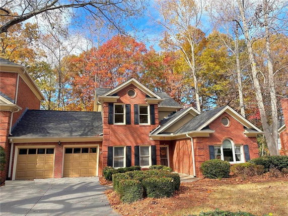 Front view of a two-story brick house with a double garage.