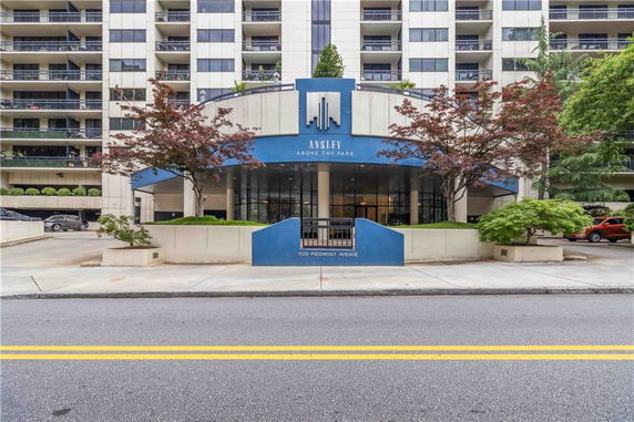 Front view of a multi-story building with balconies and a modern entrance.