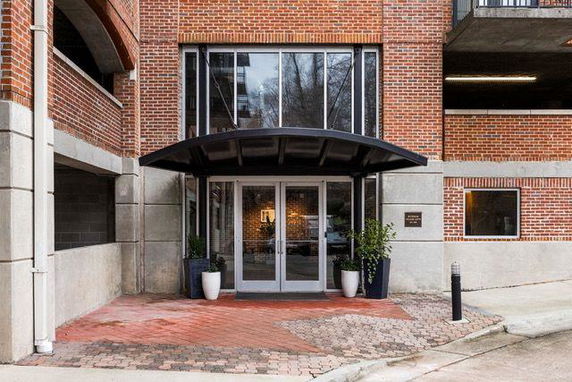 Front view of a brick building entrance with a covered entryway.