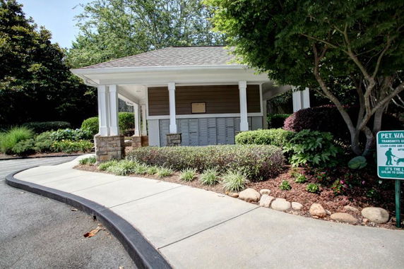 Front view of a single-story structure with covered area and multiple mailboxes.