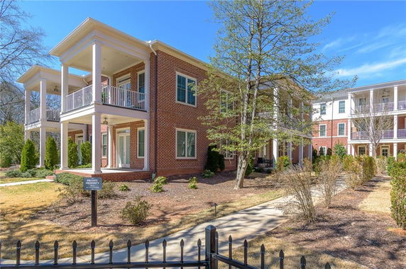 Front view of a two-story brick building with multiple balconies.