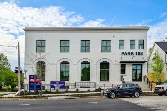 Front view of a two-story commercial building with large windows.