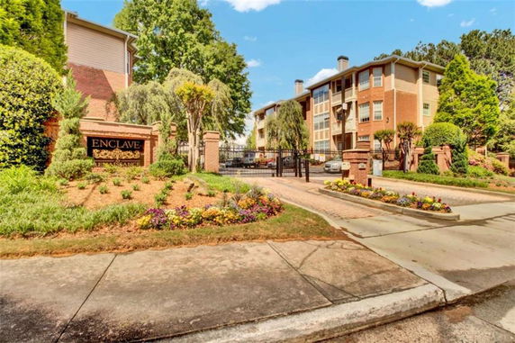 Front view of a multi-story residential building with gated entrance.