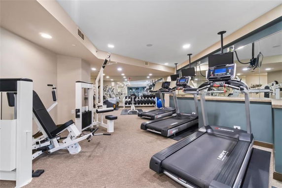 Interior view of a gym with treadmills and weight machines.