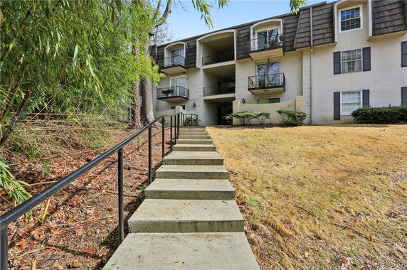 Front view of a multi-story building with balconies.