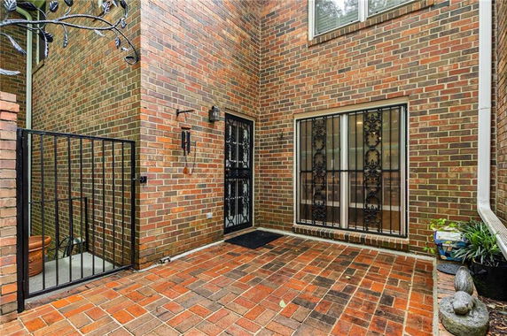 Front view of a brick exterior building with a gated entrance.