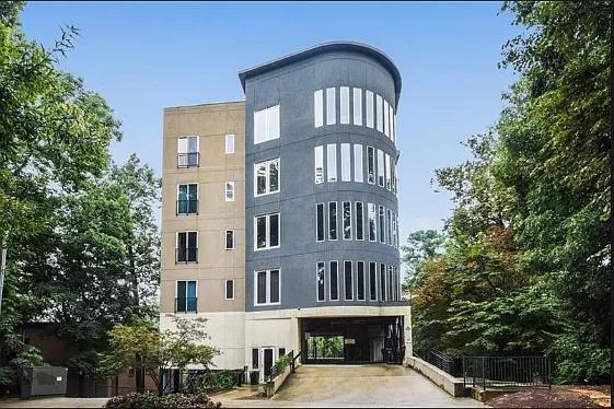 Front view of a modern multi-story building with a curved facade.