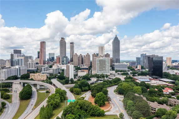 Panoramic view of a city skyline with tall buildings and highways.