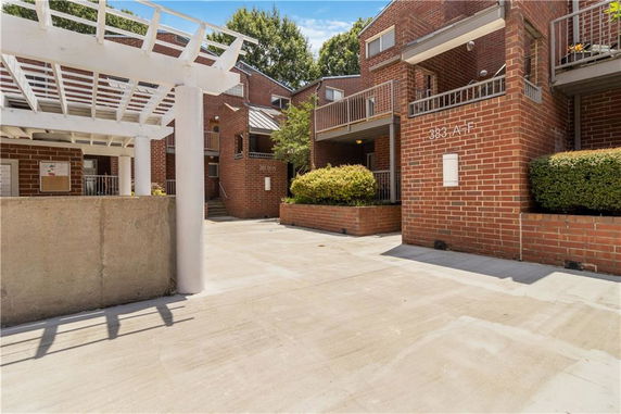 Front view of a brick residential building with balconies.