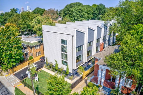 Aerial view of a modern multi-story building with a geometric facade.