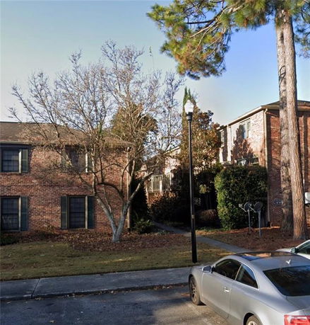 Front view of a brick two-story residential building.