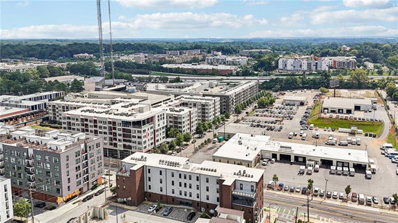 Aerial view of multiple apartment buildings with surrounding parking areas and roads.