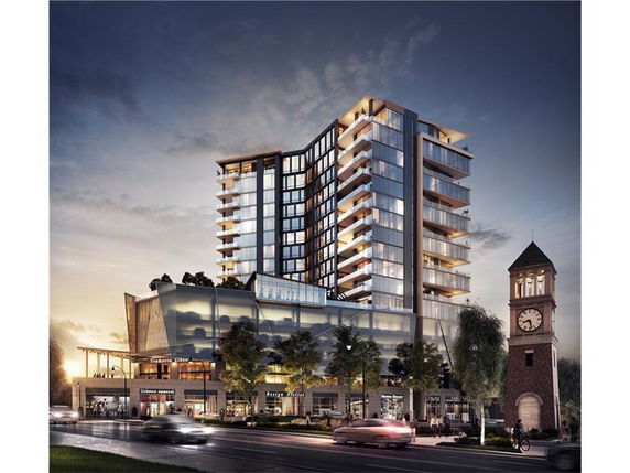 Front view of a modern multi-story building with large glass windows and balconies.