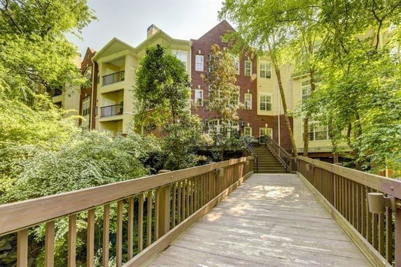 Front view of a multi-story residential building with a walkway leading up to it.