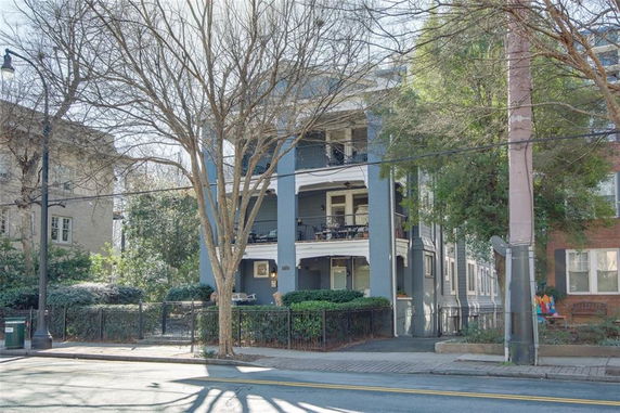 Front view of a multi-story residential building with balconies.