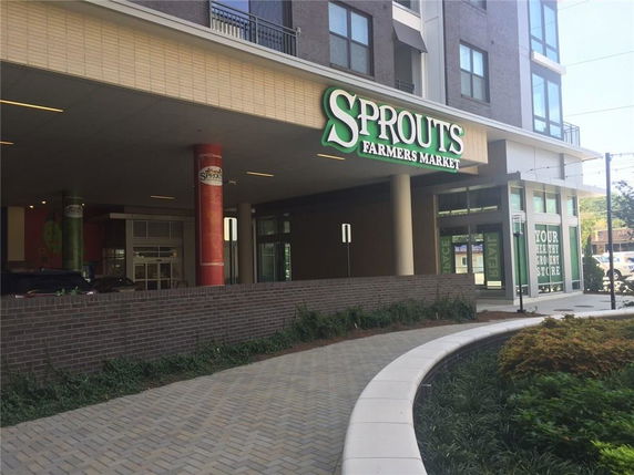 Front view of a retail store with the sign 'Sprouts Farmers Market' on the building facade.