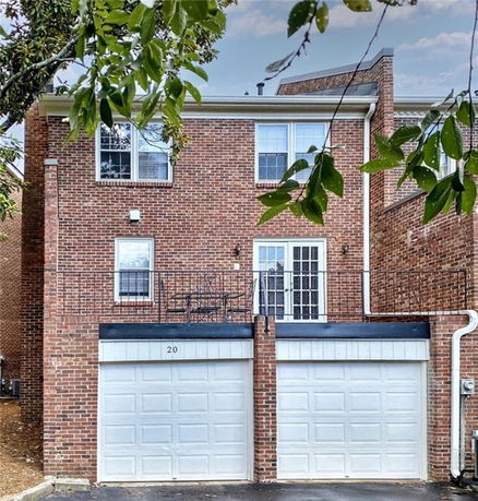 Front view of a two-story house with a brick exterior and double garage.