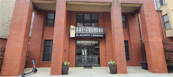 Front view of a brick building with large columns and a central entrance.