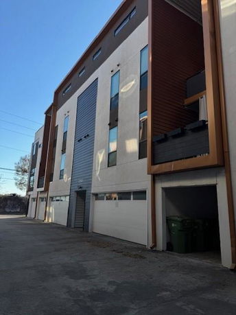 Front view of a multi-story building with garages.