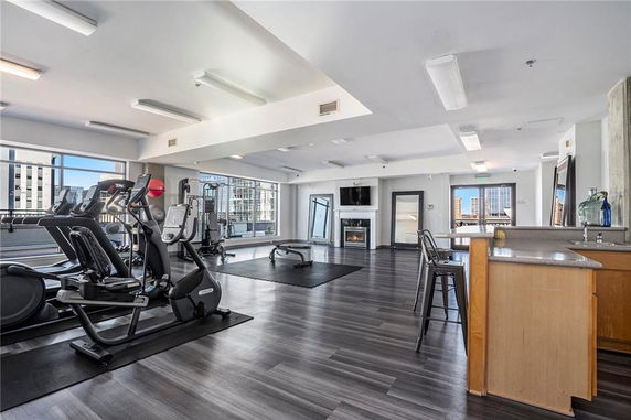 Indoor gym area with exercise equipment and large windows.