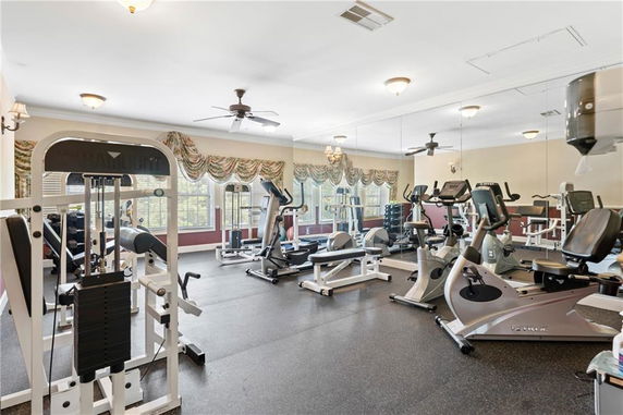 Indoor gym area with exercise equipment and mirrored walls.