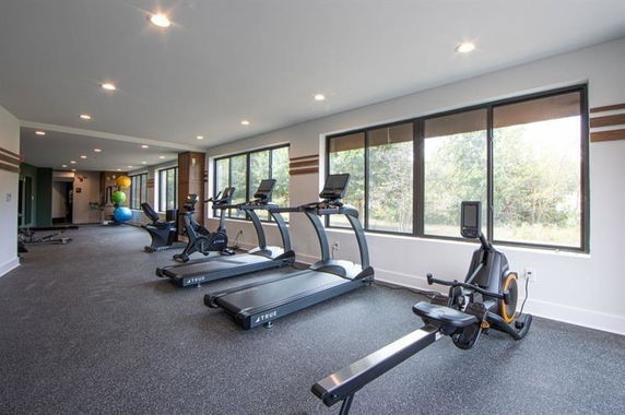 Indoor gym area with treadmills and exercise equipment.