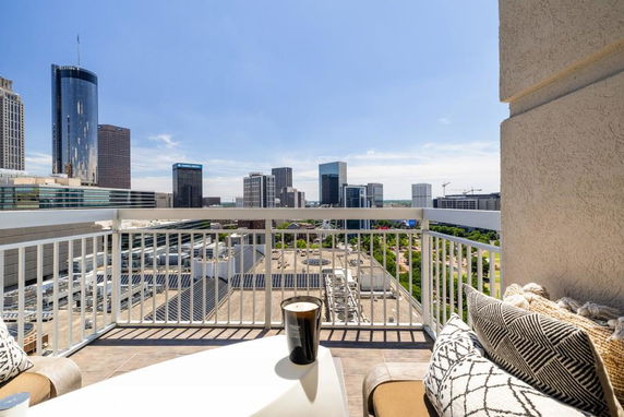 Panoramic view of a city skyline from a balcony.