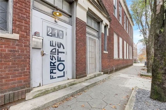 Front view of a brick building with a door labeled 'Farside Lofts.'
