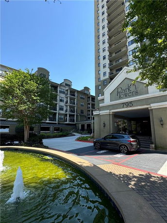 Front view of multiple-story residential buildings with an entrance area labeled Park Towers.