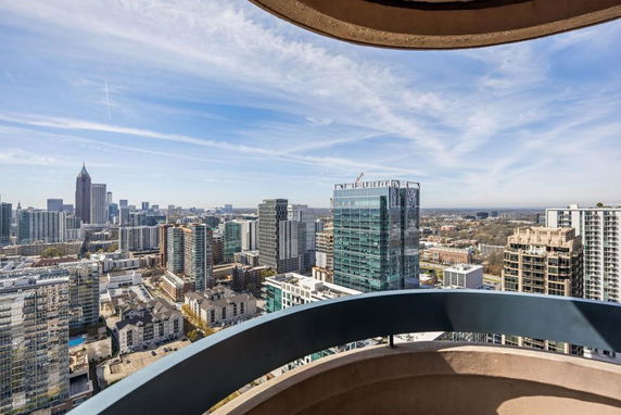 Panoramic view of a cityscape with tall buildings from a high vantage point.