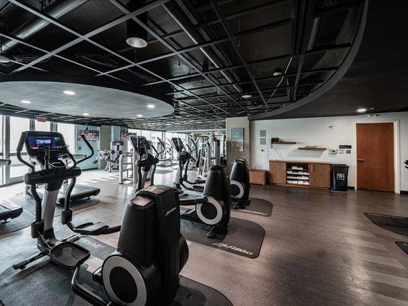 Interior view of a modern gym with exercise equipment.