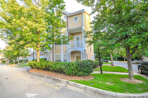Front view of a multi-story residential building with balconies.