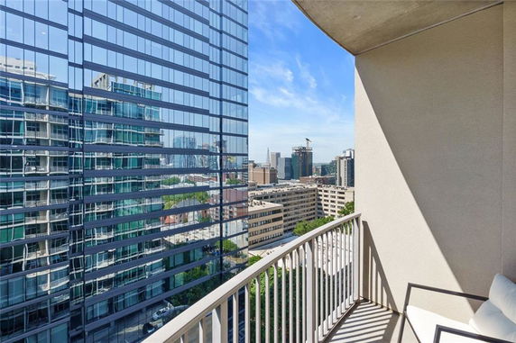 Panoramic view from a high-rise balcony overlooking surrounding buildings.