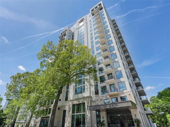 Front view of a multi-story residential building with balconies.