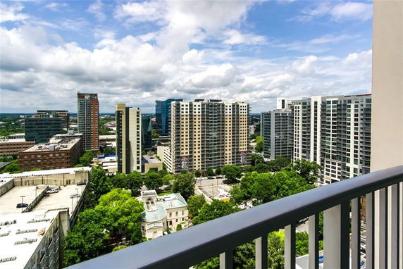 View of a cityscape with tall buildings and greenery from a high vantage point.