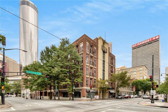 Front view of a multi-story building on a city street corner.
