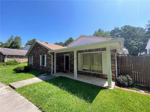 Front view of a single-story brick house with a covered porch.