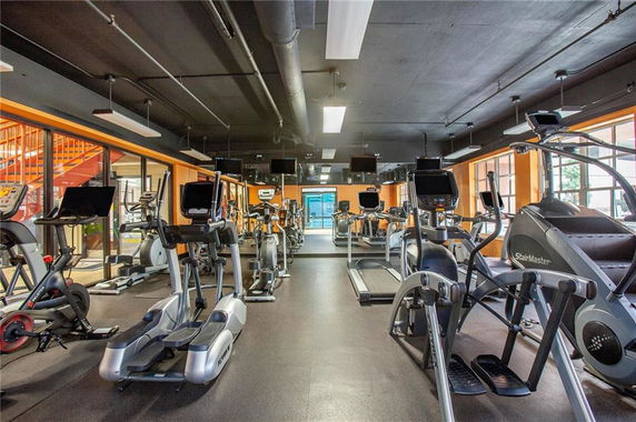 Interior view of a gym with various exercise machines and equipment.