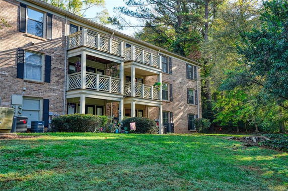 Front view of a multi-story apartment building with balconies.