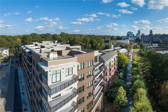 Panoramic view of a multi-story residential building with surrounding cityscape.