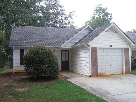 Front view of a house with an attached single garage.