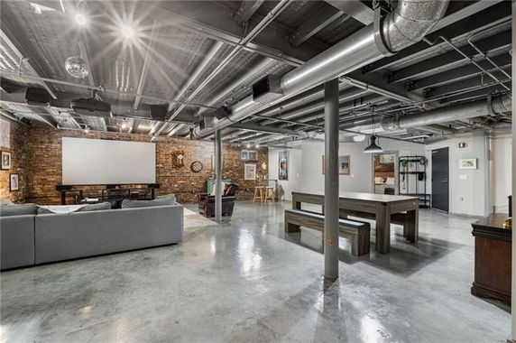 Interior view of a spacious entertainment room with seating and recreational features.