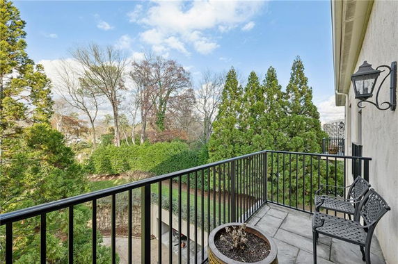 View of surrounding trees and garden from a balcony.
