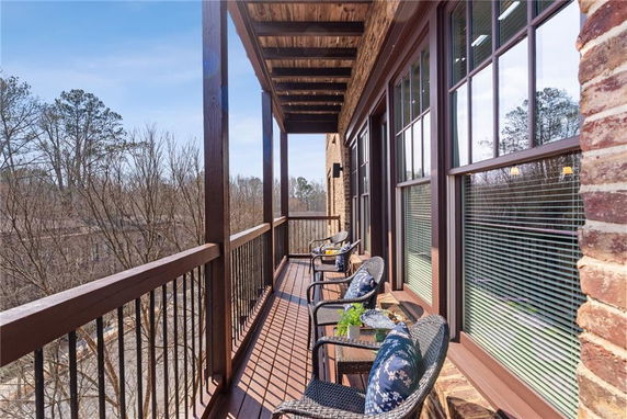 Balcony with chairs and view of surrounding trees