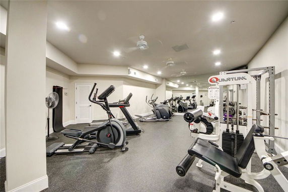 Interior view of a gym with exercise equipment and machines.