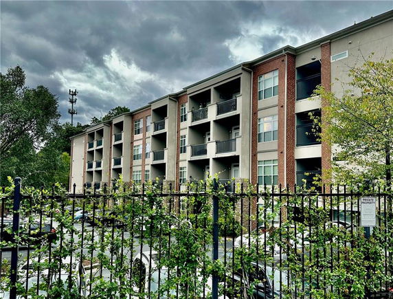 Front view of a multi-story residential building with balconies.