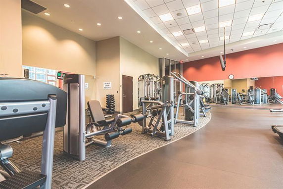 Interior view of a gym with various exercise equipment.